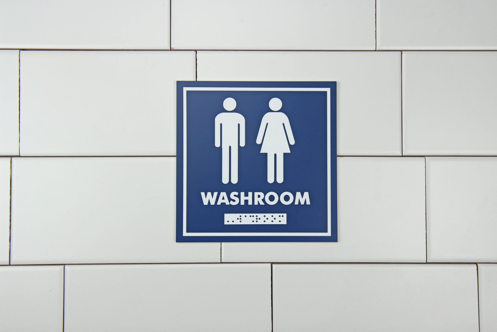 Frost Gender Neutral Washroom Sign in use